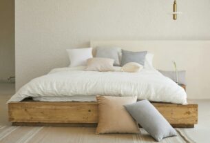 white bed pillow on brown wooden bed frame